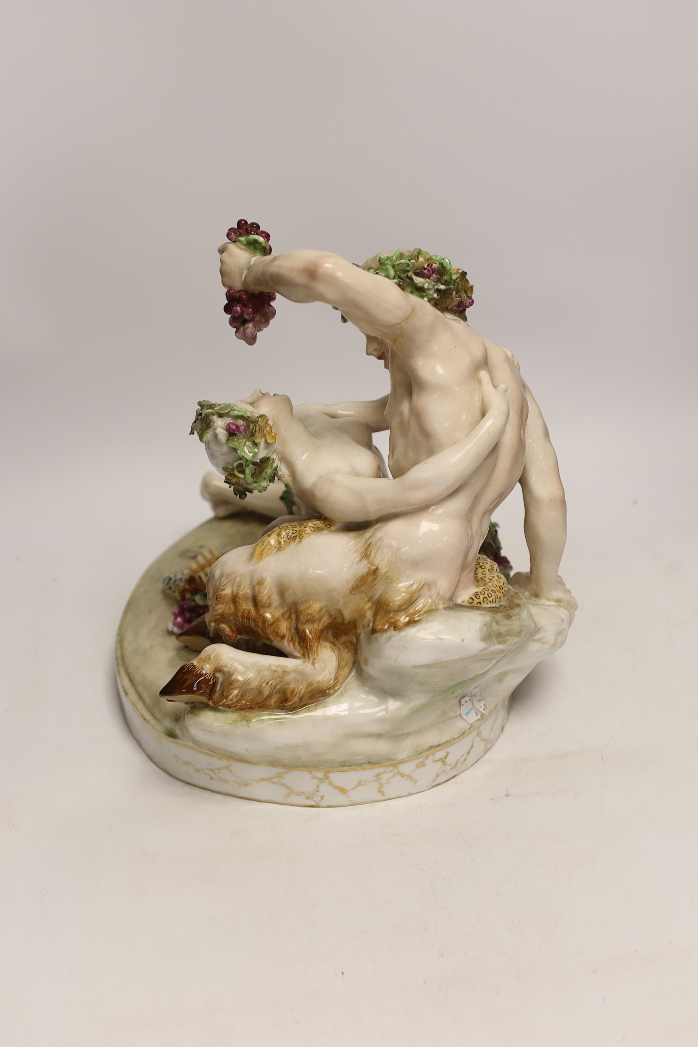 A large German porcelain Bacchus group, pseudo Meissen cross swords mark, 29cm high